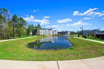 Retention pond with walkways and apartment buildings